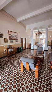a large room with a table and chairs in it at Hotel Skal Inn in Barranquilla