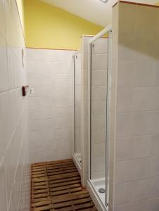 a walk in shower in a bathroom with white tiles at Caserío Areitz Soroa in Arce +39 photos