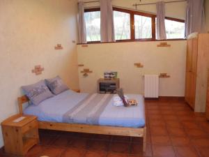 a bedroom with a bed in a room with windows at Caserío Areitz Soroa in Arce