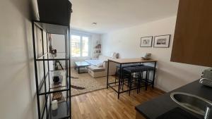 a kitchen with a living room with a table and a couch at Apartment Bjelašnica 8 - Garage parking included in Sarajevo