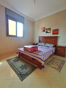 a bedroom with a bed and a window at AZULI ⵣ Hostel Mirleft in Mirleft +43 photos