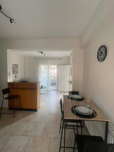 a kitchen and dining room with a table and chairs at Apartment Akanthous in Kallithea Halkidikis +32 photos