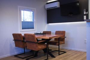 a dining room with a wooden table and chairs at Ferienhaus Noa in Twist
