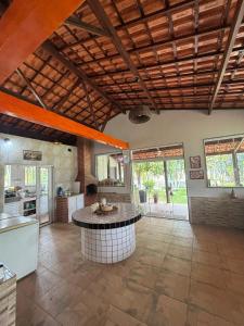 a kitchen with an island in the middle of a room at Sítio no Rio de Janeiro, privativo, Natureza, conforto e lazer em Nova Iguaçu, RJ in Nova Iguaçu +38 photos