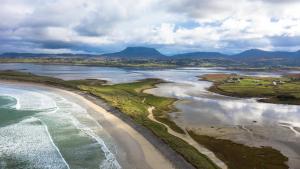 an aerial view of a beach and the ocean at Teach Hudi Beag, Bar & Accommodation Bunbeg in Bunbeg