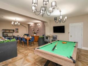 a living room with a pool table and a dining room at Rutland Grange in Filey