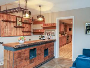 a kitchen with a reclaimed wood bar in a house at Rutland Grange in Filey