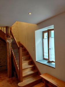 a staircase in a house with a window at Chambre sous les toits in Baule