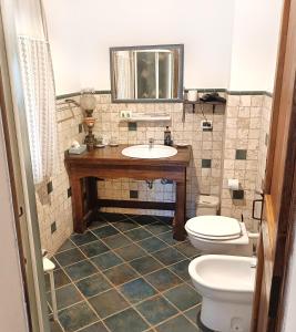 a bathroom with two toilets and a sink at Casale la Decima in Budrio +16 photos