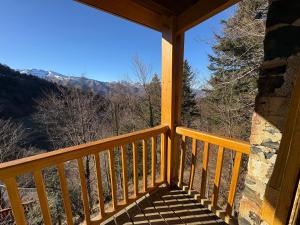 a porch with a view of the mountains at Le cosy d Asmae in Ustou +12 photos