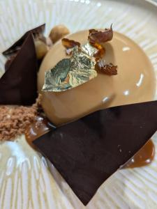 a plate with a piece of food with caramel on it at Le Château de La Pomarède in La Pomarède