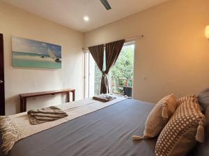 a bedroom with a large bed with a window at Tulum Nah in Tulum +38 photos