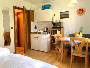 a small kitchen and dining room with a table at Ferienhaus Cosima in Schwangau