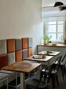 a kitchen with two tables and chairs and a counter at Expo Śniadeckich in Poznań +111 photos