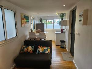 a living room with a couch and a table at Contain'House Paradise in Les Abymes