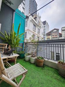 a balcony with a bench and potted plants at LoCo Fully Equipped House - 2BR3WS in Ho Chi Minh City