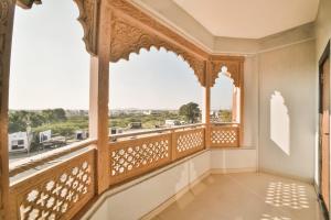a balcony with a view of the city at Capital O Amit Palace in Bhilwara