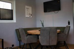 a dining room with a wooden table and chairs at Ferienhaus Aurora in Twist