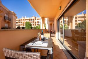a table with a bottle of wine on a balcony at Luz Beach Luxury Apartment in Luz