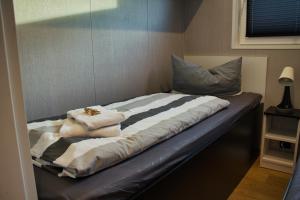 a bed with two towels and a pillow on it at Ferienhaus Aurora in Twist