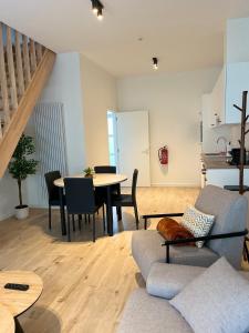 a living room with a couch and a table at FDS Luxe House in Ghent