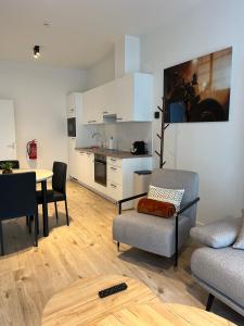a kitchen and a living room with a table and chairs at FDS Luxe House in Ghent +26 photos