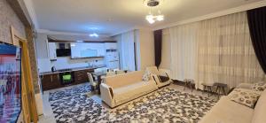 a living room with a couch and a kitchen at Onur Termal in İhsaniye