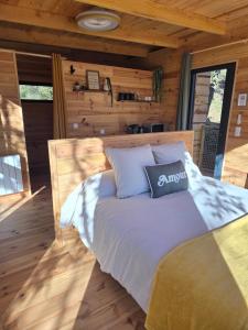 a bedroom with a bed in a log cabin at La parenthèse in Ansignan