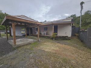 a house with a gazebo in front of it at Contain'House Paradise in Les Abymes +3 photos