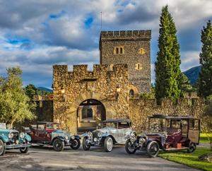 a group of antique cars parked in front of a castle at Caserío Areitz Soroa in Arce
