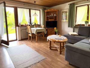 a living room with a couch and a table at Ferienhaus Cosima in Schwangau