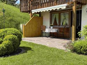 a patio with a table and chairs in front of a house at Ferienhaus Cosima in Schwangau +41 photos