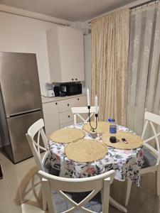 a kitchen with a table with two candles on it at Tautiului 222 apartment in Floreşti