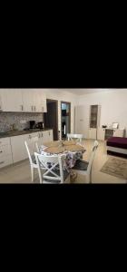a kitchen with a table and chairs in a room at Tautiului 222 apartment in Floreşti