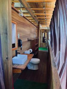a bathroom with a white sink and a toilet at Casa Frutas y Verduras in Puerto Escondido +37 photos