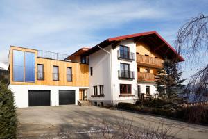 a large white building with a red roof at Haus Gerti in Ramsau am Dachstein