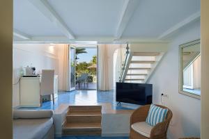 a living room with a couch and a tv at Hotel Continental Mare in Ischia Town