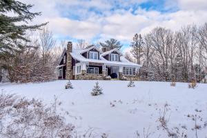 a house with snow on the ground in front at The Greenfield in Bethlehem