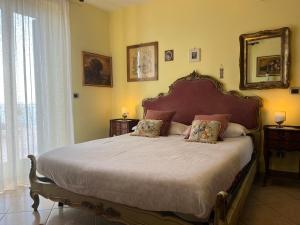 a bedroom with a large bed and a mirror at Miriam Sea Front Apartment Jacuzzi in Giardini Naxos +49 photos