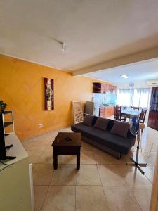 a living room with a couch and a table at Tropical Breeze Holidays in Santa Maria