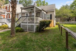 a house with a porch and a fence at Awesome Downtown Condo with Pool! in Savannah