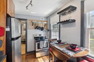 a kitchen with a table and a stove and refrigerator at Awesome Downtown Condo with Pool! in Savannah