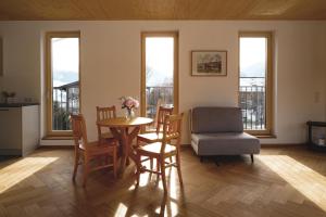 a living room with a table and a chair at Haus Gerti in Ramsau am Dachstein