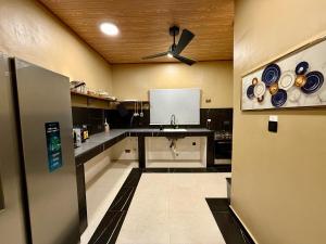 a kitchen with a sink and blue plates on the wall at Accra Luxury Apartments At The Sanga Estates in Accra