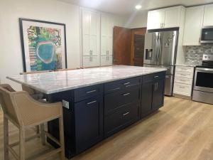 a kitchen with a large island in the middle at Brush Hill Lakehouse in Checotah