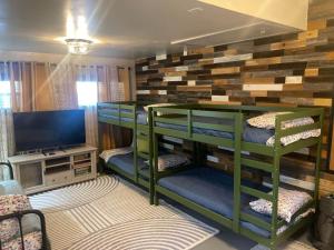 a room with bunk beds and a flat screen tv at Brush Hill Lakehouse in Checotah