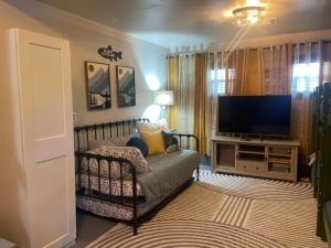 a living room with a couch and a flat screen tv at Brush Hill Lakehouse in Checotah