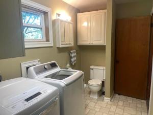 a small bathroom with a sink and a toilet at Brush Hill Lakehouse in Checotah
