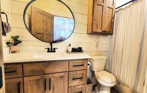 a bathroom with a sink and a mirror at The Pointe Guesthouse in Texanna