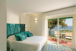 a bedroom with a bed with a view of the ocean at Hotel Continental Mare in Ischia Town +77 photos